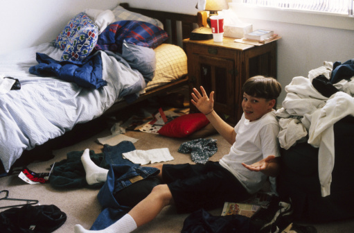 photo of boy with messy room