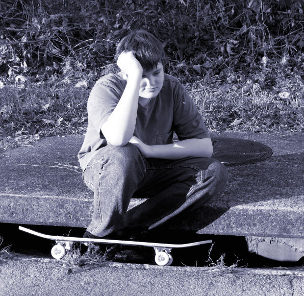 sad boy with skateboard image